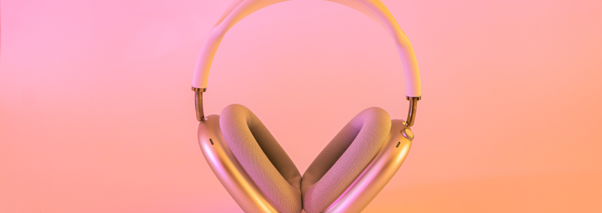 Pair of headphones against a pink and orange background